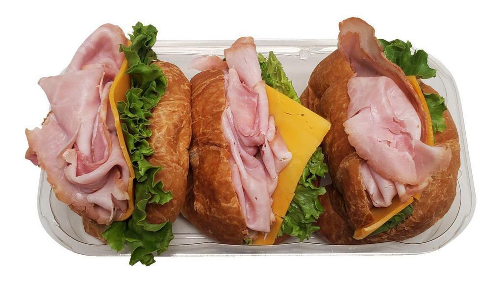 Ham Croissant Sandwiches, 3 Ct · Kretschmar ham off the bone, sliced Cheddar cheese, green leaf lettuce on a mini croissant.