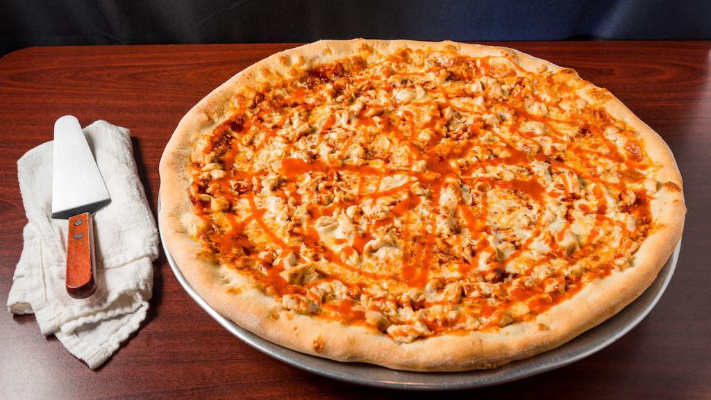 Buffalo Chicken Pizza · Hand-stretched dough with buffalo and bbq sauce, mozzarella cheese, crispy chicken strips tossed in buffalo sauce, onions, and ranch!