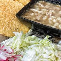 Small Chicken Pozole · Chicken soup with hominy and shredded chicken, on the side green cabbage, radishes, and onio...