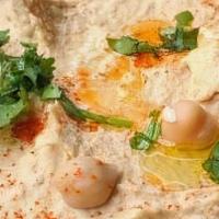 Hummus · Most popular. Tahini sauce, garlic, lemon juice, garbanzo beans blended and topped with oliv...