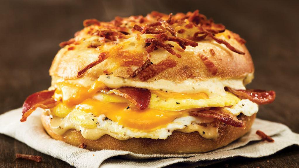All-Nighter Egg Sandwich · Cheesy Hash Brown gourmet bagel with American cheese, bacon, eggs and a jalapeno garlic aioli.