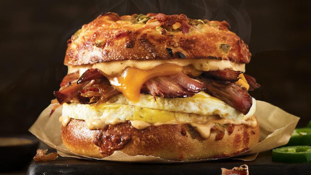 Texas Brisket Sandwich · Cage-free fresh-cracked eggs, smoked beef brisket, cheddar with smoky chipotle aioli  on a new Jalapeño Bacon Gourmet Bagel.