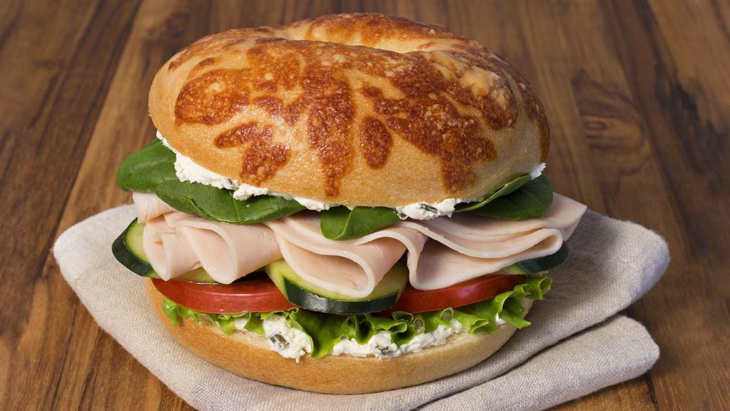 Tasty Turkey Sandwich · Asiago Bagel with turkey, spinach, cucumber, lettuce, tomato and onion and chive shmear.