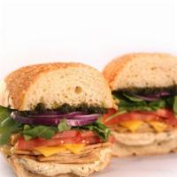Divine Love | Chick'N Pesto · Chickn Pesto Sandwich stacked with chicken-free, provolone cheese, arugula, red onion, tomat...