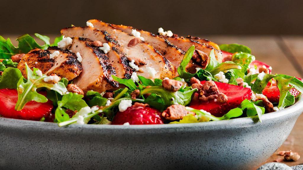 New!  Strawberry Salad · Wild arugula and crisp romaine lettuce with fresh strawberries, cinnamon pecans and goat cheese crumbles, tossed in a raspberry vinaigrette.  Topped with your choice of grilled or crispy chicken.