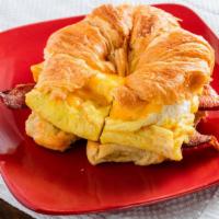 Breakfast Croissant · Three scramble eggs, American cheese, mayo and meat of your choice between bacon, sausage li...