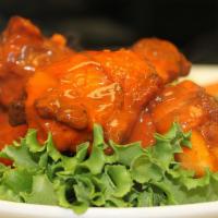 Buffalo Wings (Bone In) · Hot, Hot, Hot! Spicy chicken wings served with celery, carrot sticks and ranch dressing.