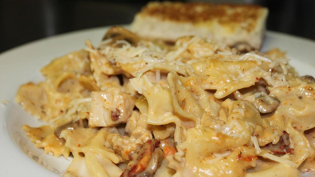 Blacken Chicken Pasta · Tender chicken breast, bow tie pasta with alfredo sauce, smoked bacon, sun dried tomatoes, mushrooms, tossed in a creamy parmesan sauce.