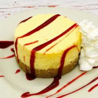 New York Cheesecake · A big, thick slice served with raspberry sauce.