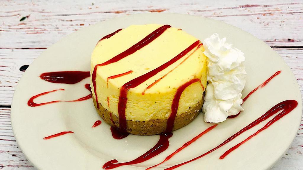 New York Cheesecake · A big, thick slice served with raspberry sauce.