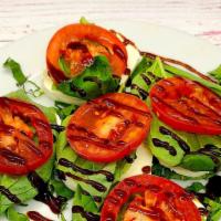 Caprese Salad · Roma Tomato slices, fresh mozzarella, fresh basil and balsamic glaze.