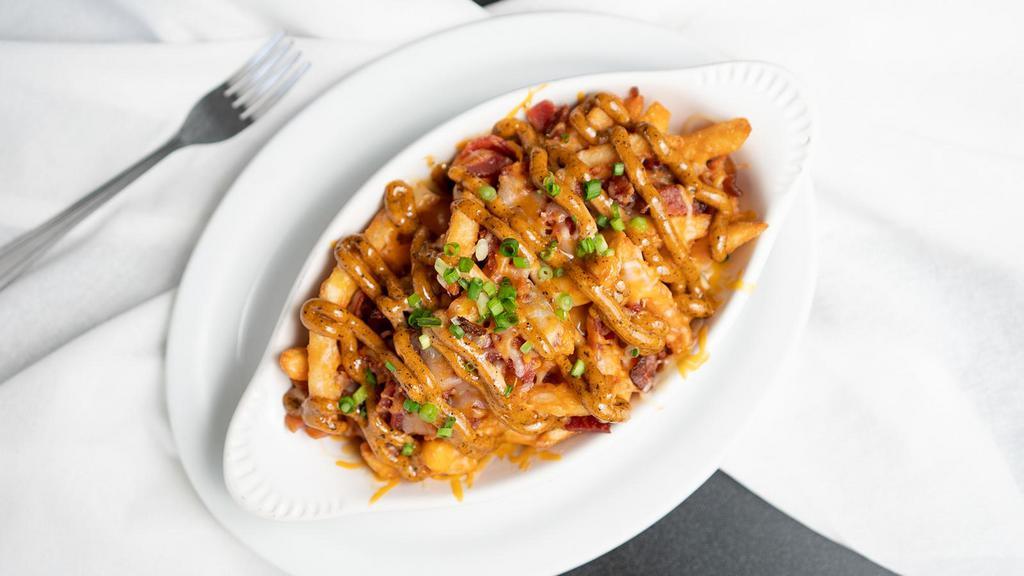 Cajun Taters · Bacon, green onion, Cajun spice & sauce. Choice of beer cheese sauce or melted shredded cheddar-jack.