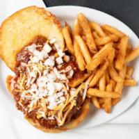 Chili Burger · fork and knife style, cheddar, dry bun, topped with onion and shredded cheese.