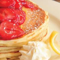 Fresh Strawberry Pancakes · Our delicious buttermilk pancakes ladled with a fresh strawberry topping and fresh whipped c...