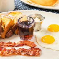 Golden Crisp French Toast Combo · French toast served with two eggs and your choice of bacon or sausage patties or links.