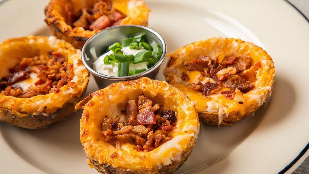 Hof’S Classic Skins · Crisp potato skins with melted cheese, layered with crumbled bacon. Served with sour cream and chives.