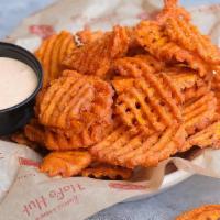 Sweet Potato Waffle Fries · Crispy sweet potato fries perfectly seasoned with our house BBQ spice. Topped with parsley a...