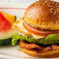 Chicken Club · Grilled chicken breast, melted swiss cheese, bacon, lettuce, tomatoes, and mayo on a sesame ...