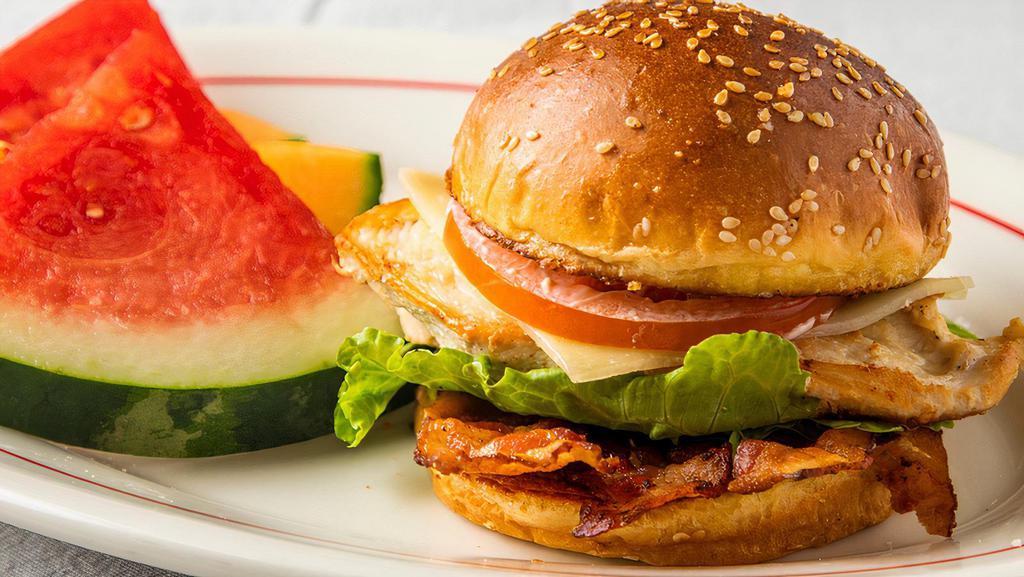 Chicken Club · Grilled chicken breast, melted swiss cheese, bacon, lettuce, tomatoes, and mayo on a sesame brioche  bun.