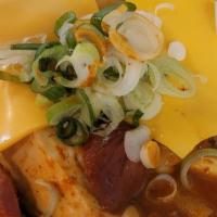 Army Stew · Our spicy twist on traditional kimchi stew with added spam, sausages, american cheese and ra...