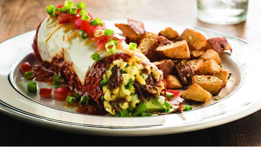 Chipotle Breakfast Burrio · Flour tortilla stuffed with braised beef, melted jack and cheddar cheese, scrambled eggs, avocado, tomato, jalapeno, green onion, and cilantro. Topped with spicy chipotle sauce and served with roasted potatoes. (1450 cal)
