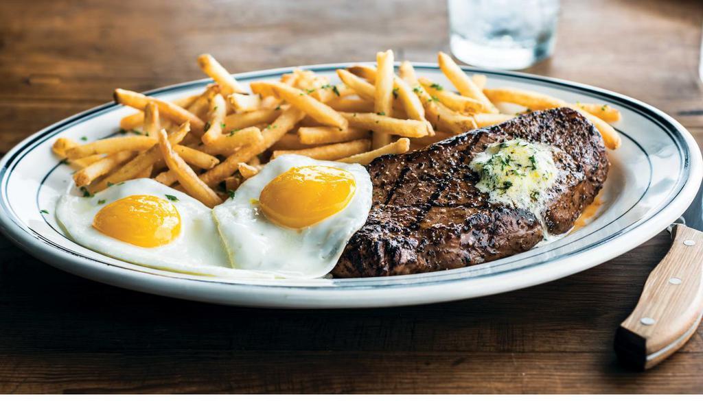 Steak & Egg · 28-day aged 10 Ounce USDA choice new York strip. House-made herb butter available upon request. Served with Roasted Potatoes and two eggs. (1090 cal) .
