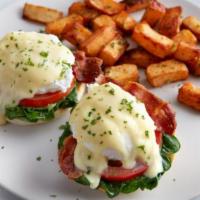Florentine Benedict · Bacon, poached eggs, spinach and sliced tomatoes topped with hollandaise sauce on a grilled ...