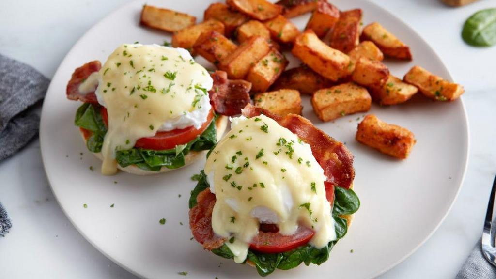 Florentine Benedict · Bacon, poached eggs, spinach and sliced tomatoes topped with hollandaise sauce on a grilled English muffin. Served with a side of roasted potatoes. (760 сal) Available every day until 2:00PM