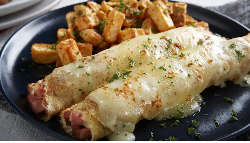 Ham & Cheese Crepes · Thick-cut ham and melted swiss cheese topped with a creamy mornay cheese sauce. Served with roasted potatoes. (710 Cal).