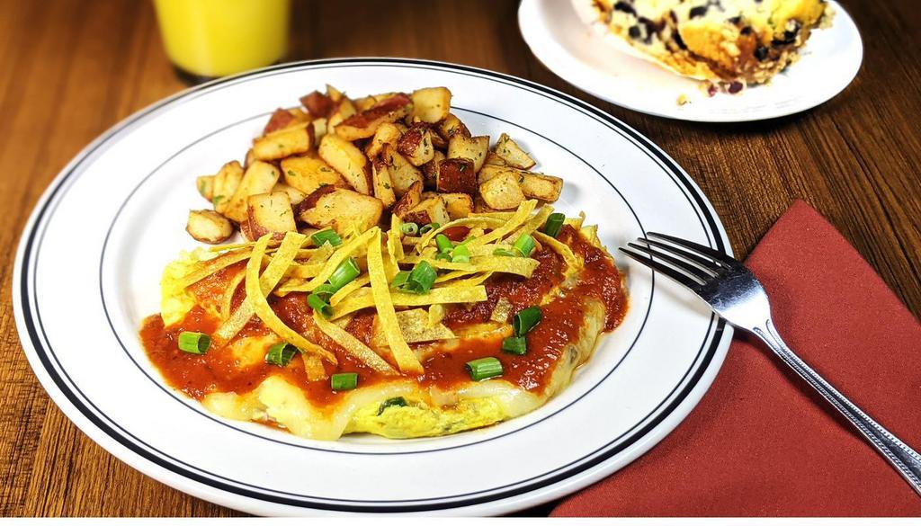 Santa Fe Omelet · Three eggs, diced jalapenos, cilantro, tomatoes, onions, tortilla strips, melted monterey jack cheese and chipotle sauce, Served with roasted potatoes. (740 cal.)