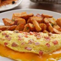 Bacon Ham & Sau Omelet · Three eggs, hickory-smoked bacon, ham, pork sausage, andouille sausage, tomato and melted ch...