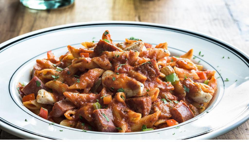 Jambalaya · Shrimp, chicken and andouille sausage, bell peppers and onions in a French Basque tomato sauce. Served over penne pasta or long grain rice, your choice. (780-790 Cal)