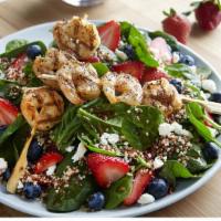 Spinach Quinoa Sal W/Shr · Two shrimp skewers, strawberries, blueberries, feta and quinoa on baby spinach tossed in fat...