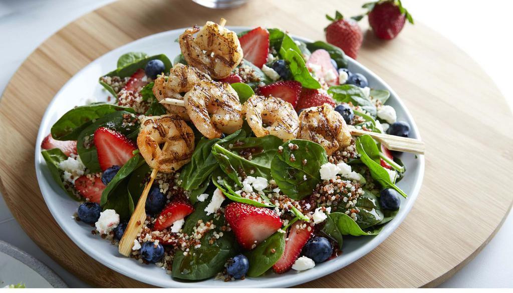 Spinach Quinoa Sal W/Shr · Two shrimp skewers, strawberries, blueberries, feta and quinoa on baby spinach tossed in fat-free raspberry vinaigrette. (560 cal) .
