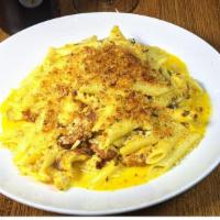 Chicken Cheddar Mac · Roasted chicken, crumbled bacon with penne in a rich cheddar sauce baked with a parmesan cru...