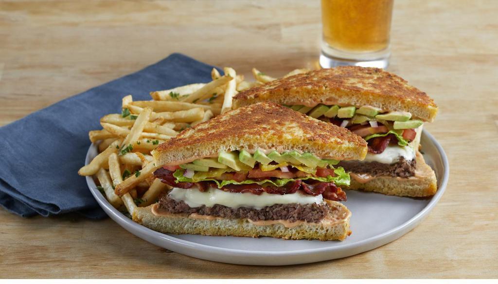 Quarter Burger · 100% USDA premium beef patty, crisp bacon, swiss cheese, avocado, lettuce, tomato, red onion, pickles and thousand island dressing on grilled garlic-parmesan sourdough bread. (1280 Cal)