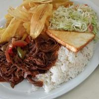 Shredded Beef/ Carne Desmenuzada · Shredded beef, served with fried rice mixed with beans, handmade plantain chips, fried chees...