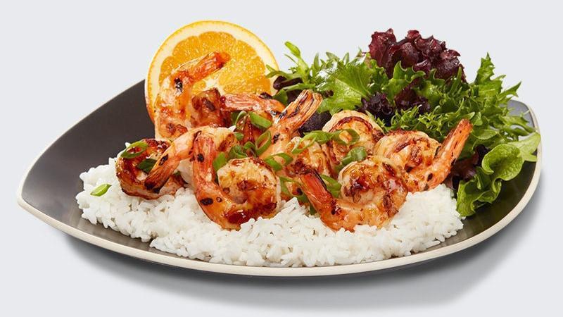 Shrimp Plate · Grilled savory jumbo shrimp hand basted with our signature Waba sauce. Served on a bed of rice with a side of arcadian salad blend and seasonal fruit.