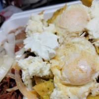 Chilaquiles Verdes  · Chilaquiles Verdes with a side of rice and beans topped off with sour cream and queso fresco...