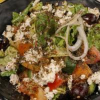 Greek Salad · Spicy. A mix of lettuce, tomatoes, and onions topped with feta cheese, oregano and olives, w...