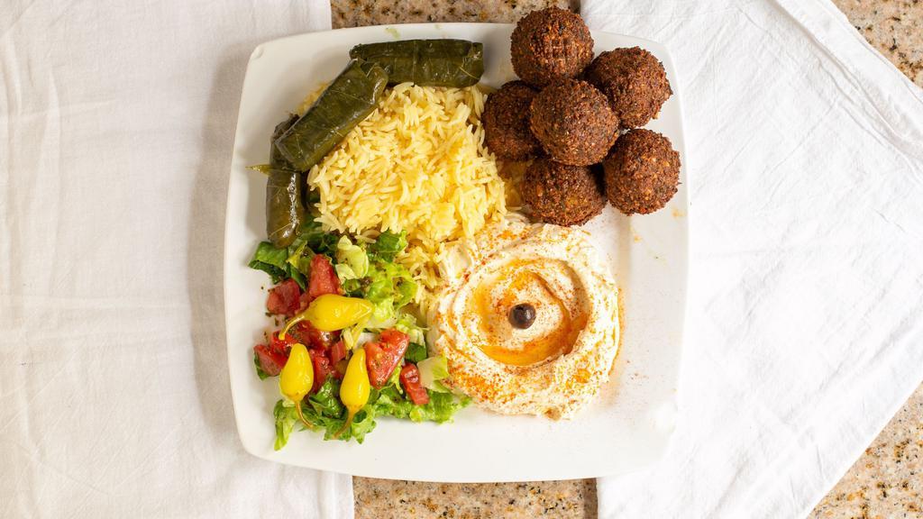 Falafel Plate · Spicy. Mix of golden garbanzo beans with garlic, onions, herbs and spices. Served with salad, hummus, tahini sauce and pita bread.
