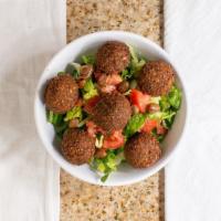 Falafel Bowl · Vegetarian. Tahini sauce. Layers of rice, spicy fava beans, sauce, lettuce, tomatoes, and ho...