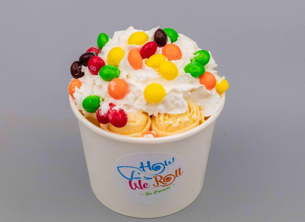 Orange Sorbet Ice Cream · Vanilla base with Orange Kool-aid inside, and topped with Whipped Cream and Skittles.
