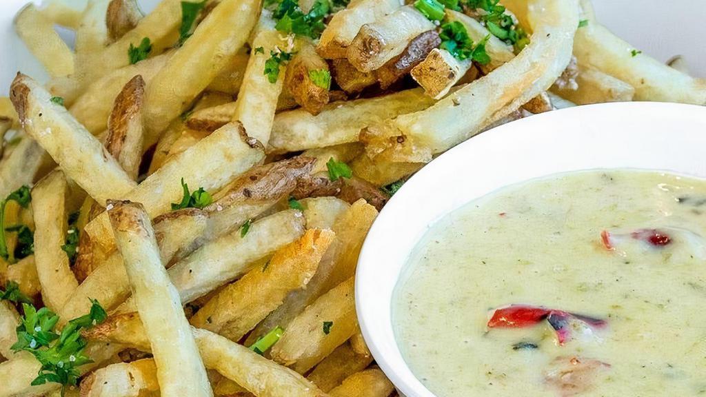Green Chile Queso Fries · Hand-cut fries served with our famous Queso for dipping. This item is gluten friendly.  If you have an allergy, please let the kitchen know.