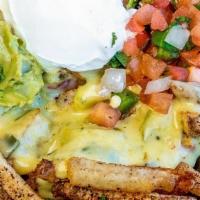 Nacho Fries · Hand-cut fries loaded with queso, pico de gallo, guacamole & sour cream. This item is gluten...