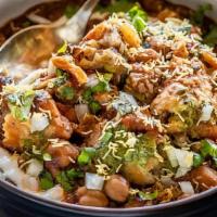Samosa Chaat · Vegetarian. Chopped samosa smothered with garbanzo beans and topped with yoghurt, onions, ci...