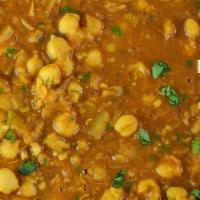 Chana Masala · Vegetarian. Vegan, garbanzo beans cooked with tomatoes, onions, herbs and spices.