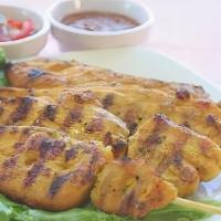 Chicken Satay · Marinated chicken strips on skewers, grilled and served with peanut sauce and sour sauce. Av...