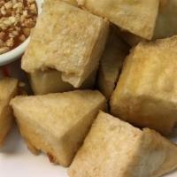 Fried Tofu · Deep-fried lightly flour bean curd served with sweet and sour sauce topped with crushed pean...