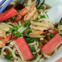 Udon Seafood Noodle Soup · Udon noodles with shrimps, fish, mussels, squid, carrot, and green onions.